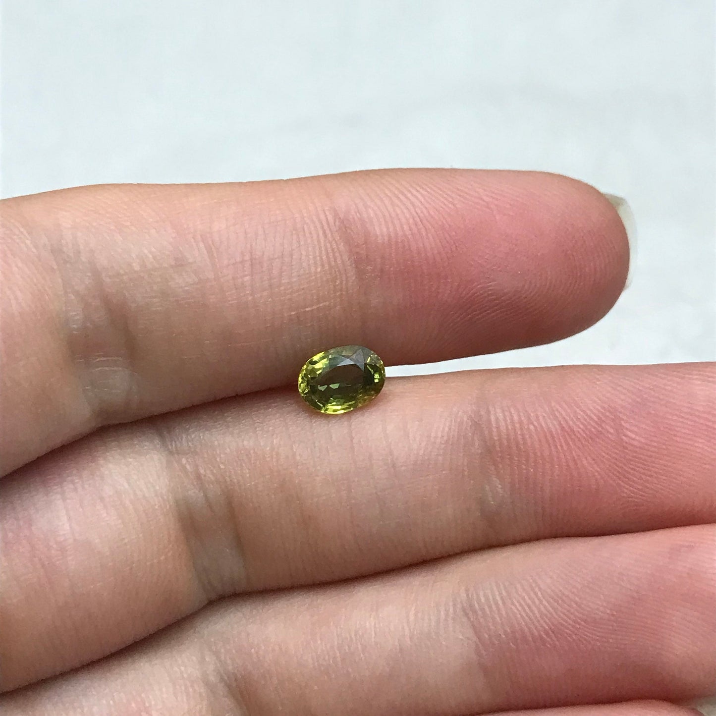 Yellow Green Sapphire 1.07 carat 6.7x5mm Oval Cut, BE Treated, Beryllium Treated Sapphire