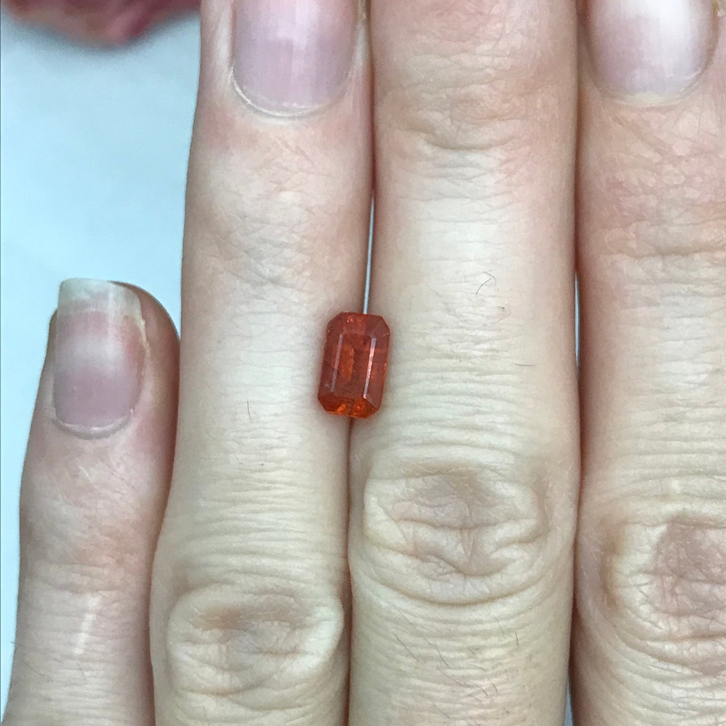 1.57 ct Natural Orange Sapphire 7.7x4.7mm Emerald Cut Loose Faceted Gem, Reddish Orange Beryllium Treated Sapphire