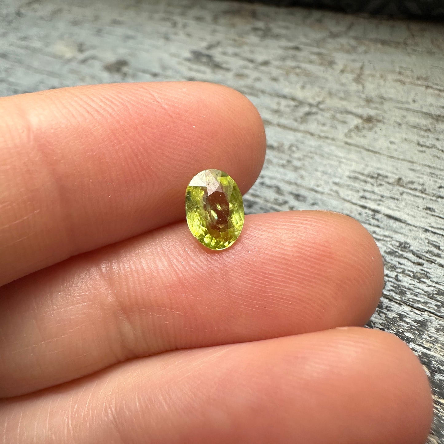 0.93 Yellow Green Sphene with Rainbow Flashes 7.3x5.3mm Oval Cut, Faceted Loose Titanite