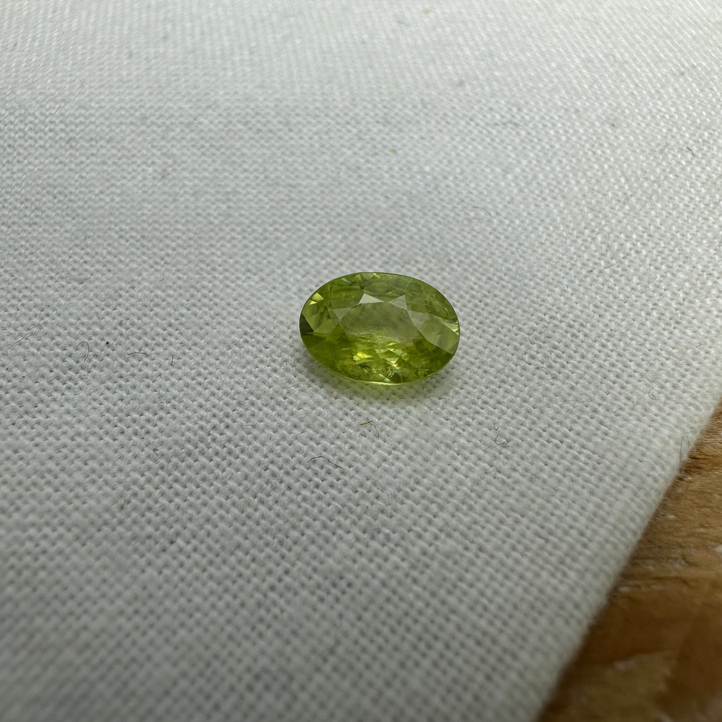 0.93 Yellow Green Sphene with Rainbow Flashes 7.3x5.3mm Oval Cut, Faceted Loose Titanite