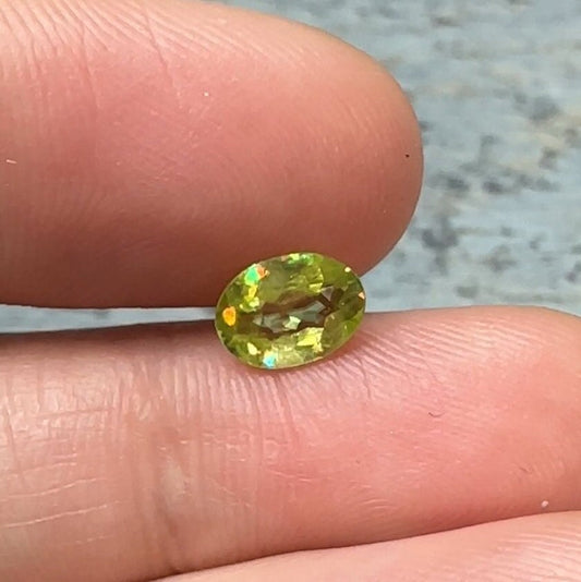 0.93 Yellow Green Sphene with Rainbow Flashes 7.3x5.3mm Oval Cut, Faceted Loose Titanite