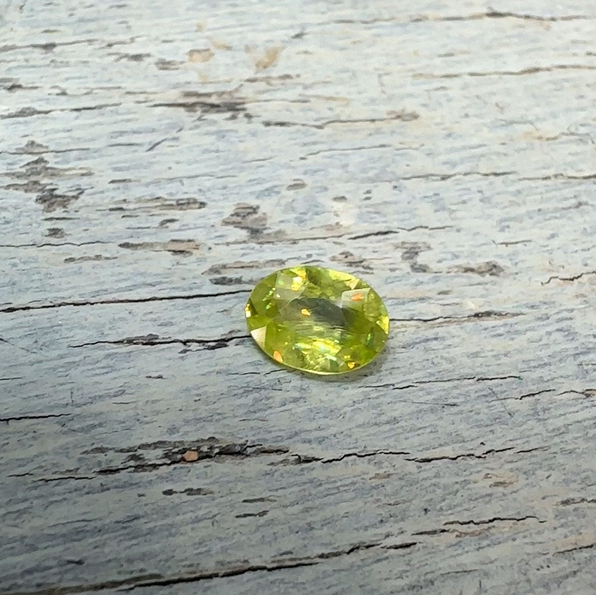 0.93 Yellow Green Sphene with Rainbow Flashes 7.3x5.3mm Oval Cut, Faceted Loose Titanite
