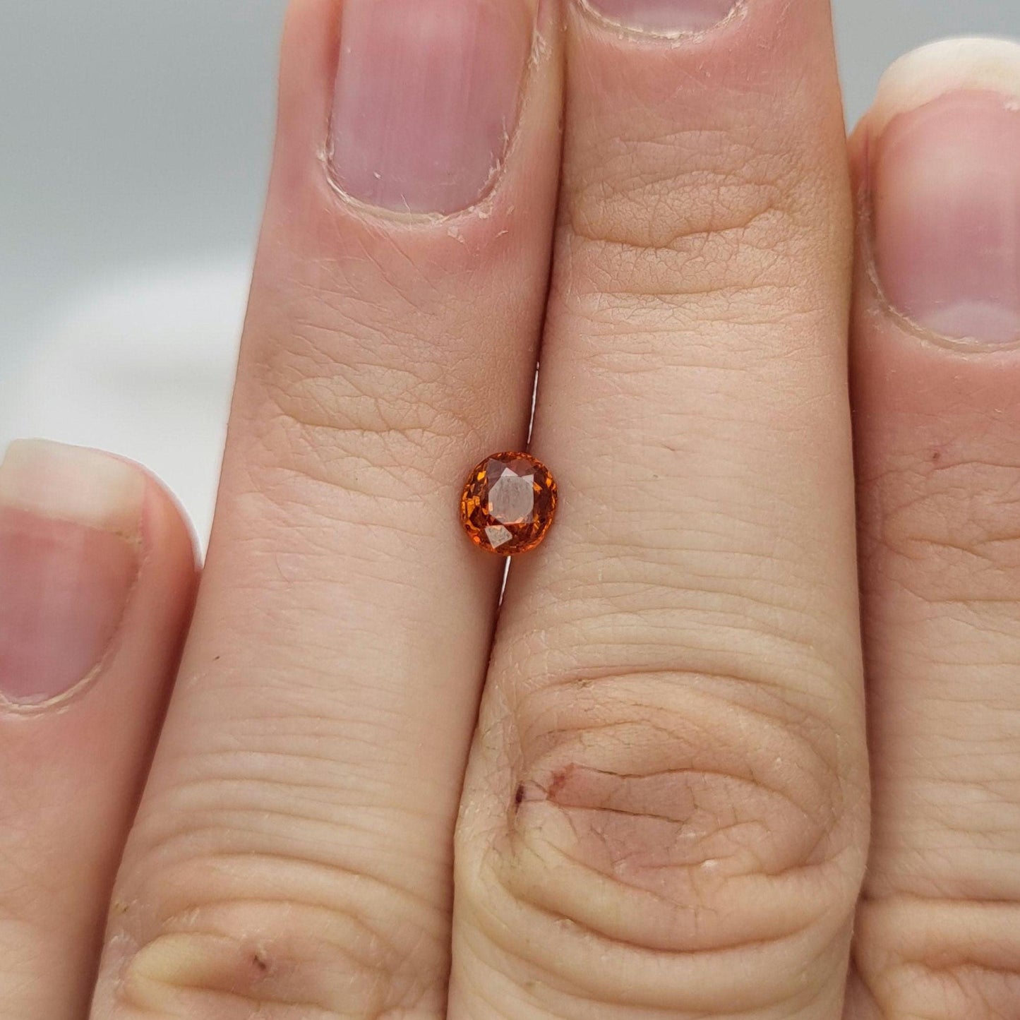 0.62 carat 5x4.3mm Natural Mandarin Spessartite Garnet, Faceted Oval Gemstone, Orange Garnet