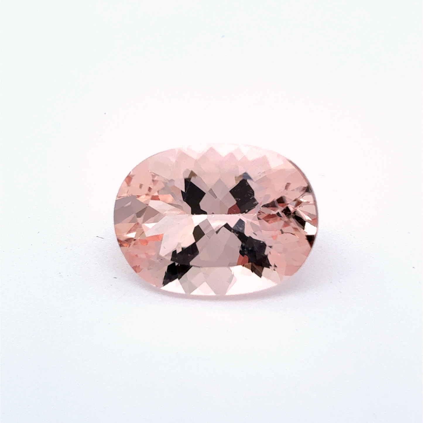 Oval-shaped pink gemstone on a white background