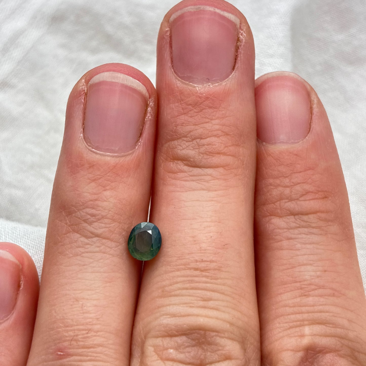 Natural Bluish Green Mermaid Sapphire 0.77 carat 5.5x4.8mm Oval Cut, Heated