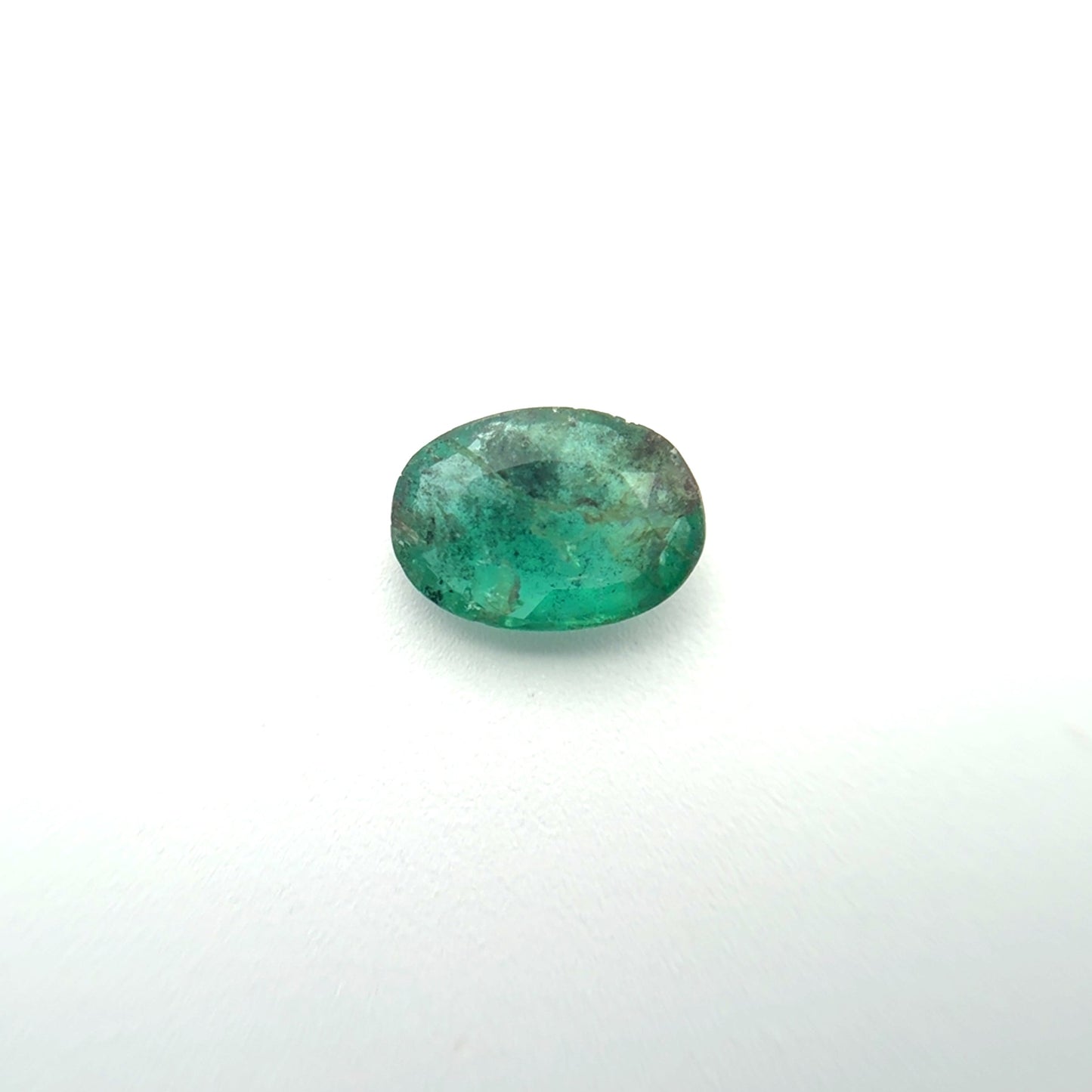 Green gemstone on a white background