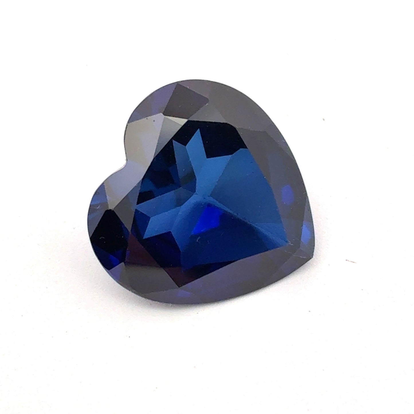 Heart-shaped blue gemstone on a white background