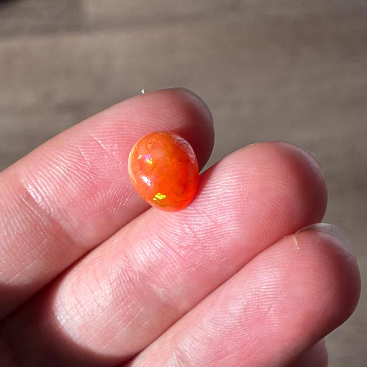 3.16 carat Orange Opal 10.8x9.2mm Oval Cabochon