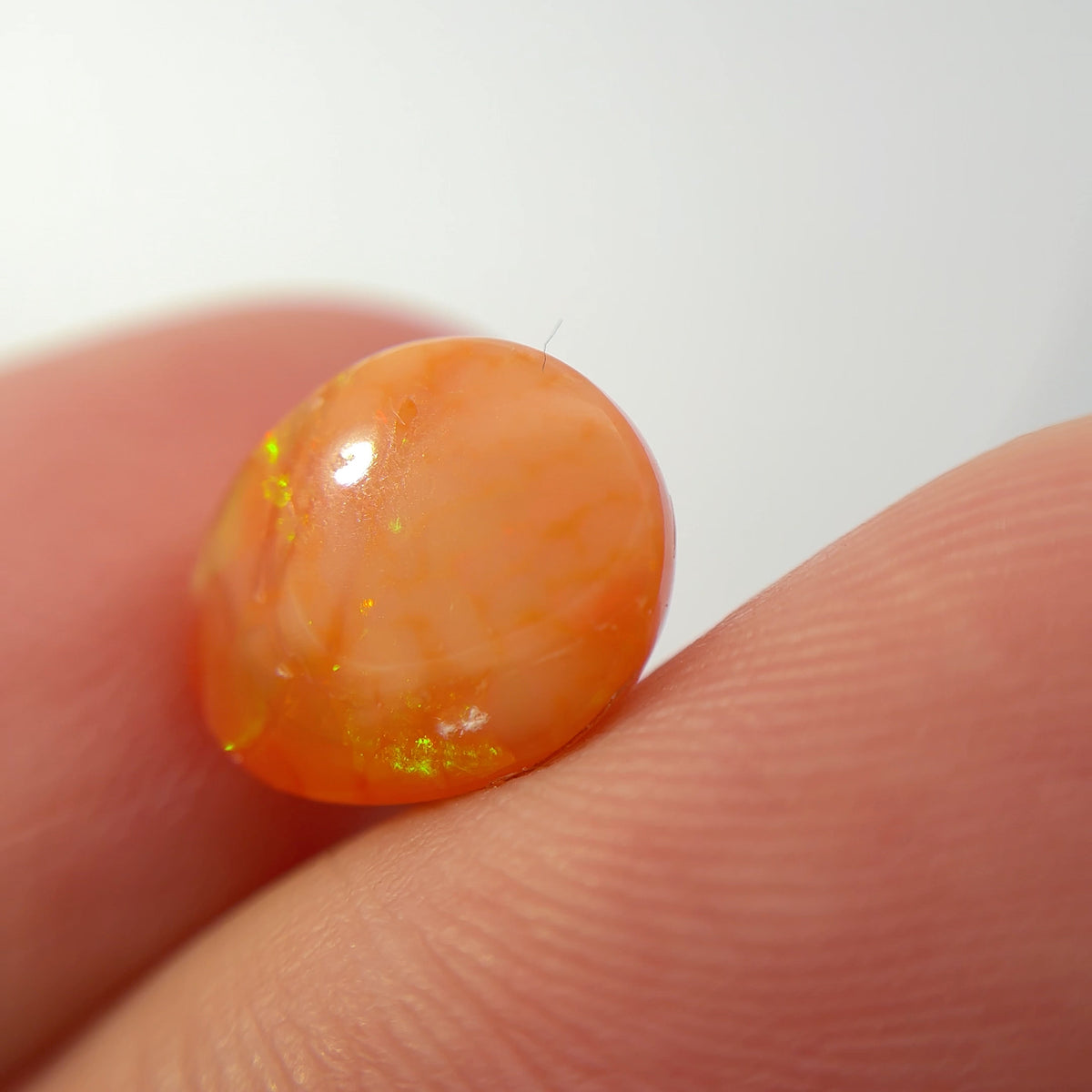 3.16 carat Orange Opal 10.8x9.2mm Oval Cabochon