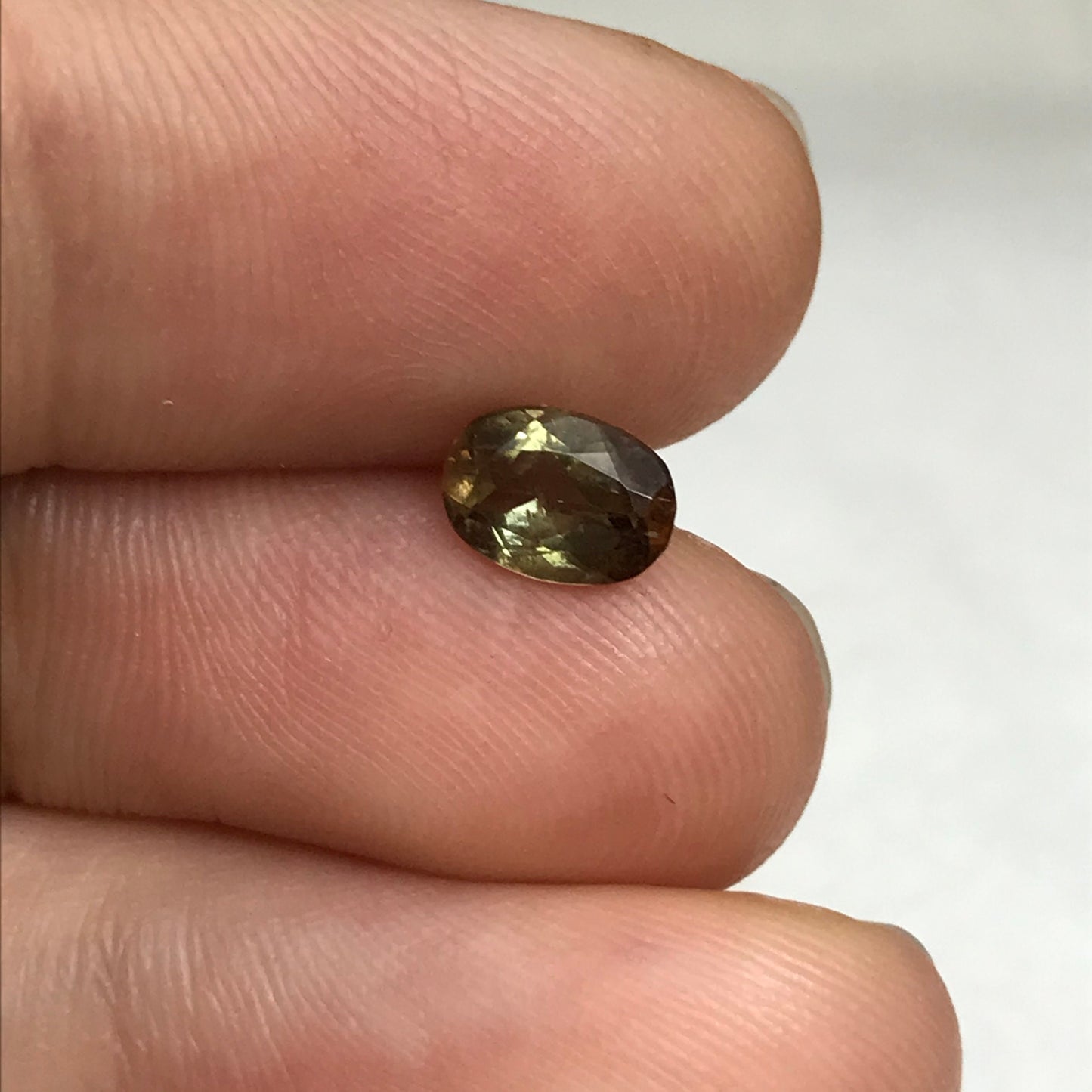 Andalusite 0.72 carat 7x5mm Oval Cut, Faceted Loose Unmounted Gemstone, Green Brown Pleochroism Bicolor Gemstone