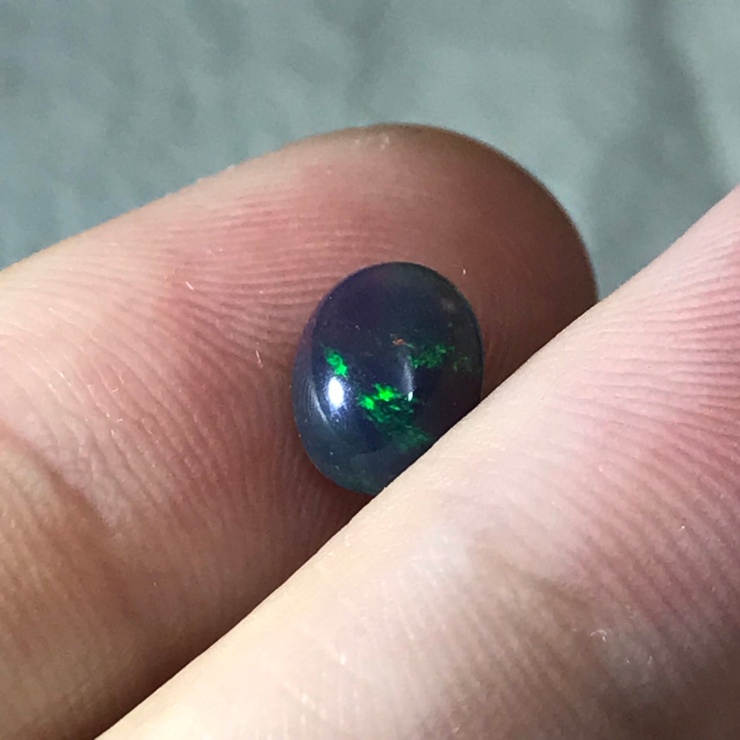 Black Opal 0.98 carat 8x6.5mm Oval Cabochon, Green Orange & Yellow Play of Color, Smoke Enhanced Natural Opal