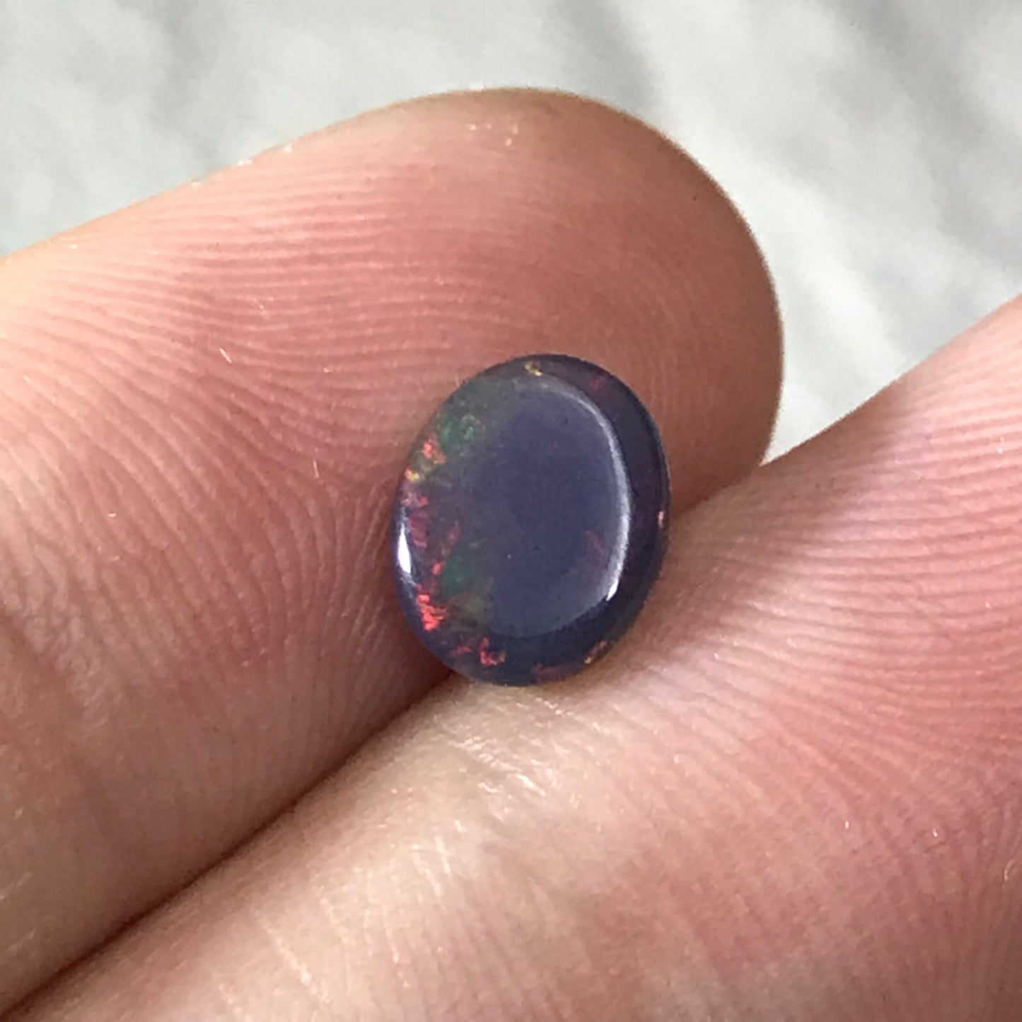 Black Opal 0.98 carat 8x6.5mm Oval Cabochon, Green Orange & Yellow Play of Color, Smoke Enhanced Natural Opal