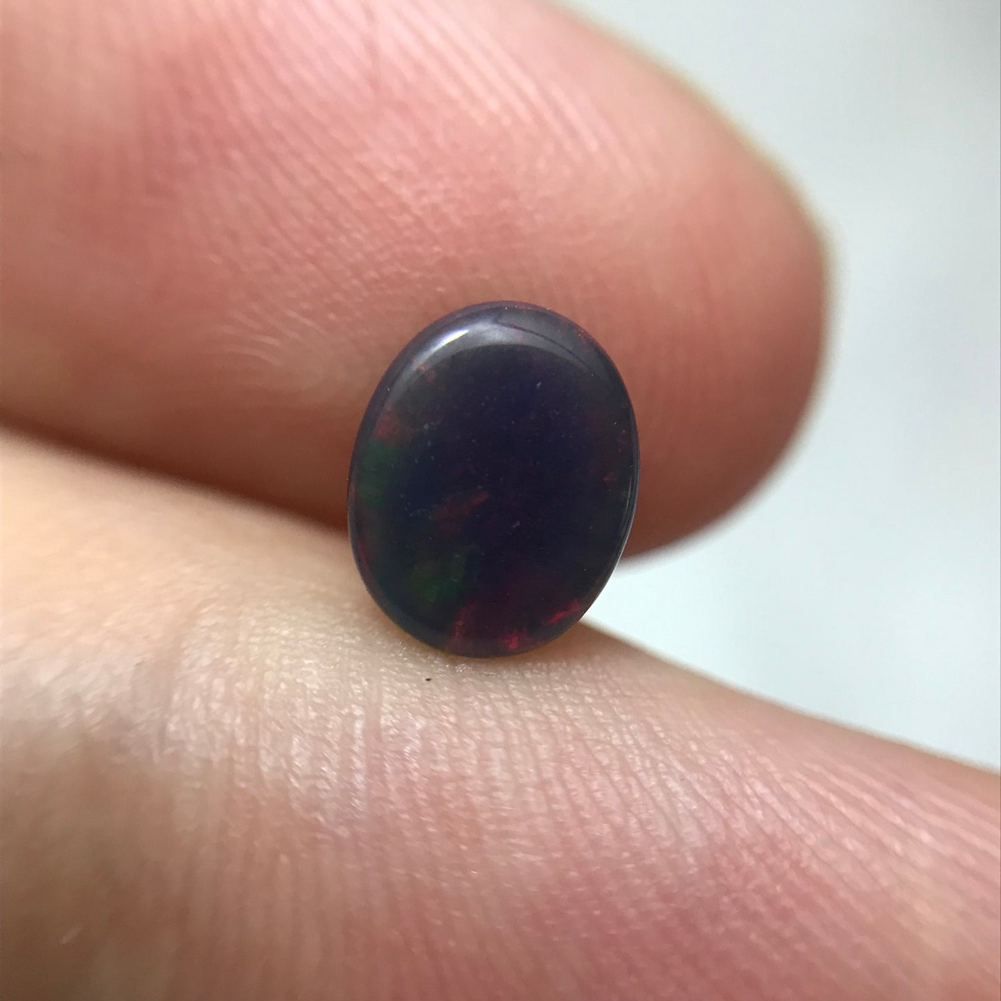 Black Opal 0.98 carat 8x6.5mm Oval Cabochon, Green Orange & Yellow Play of Color, Smoke Enhanced Natural Opal