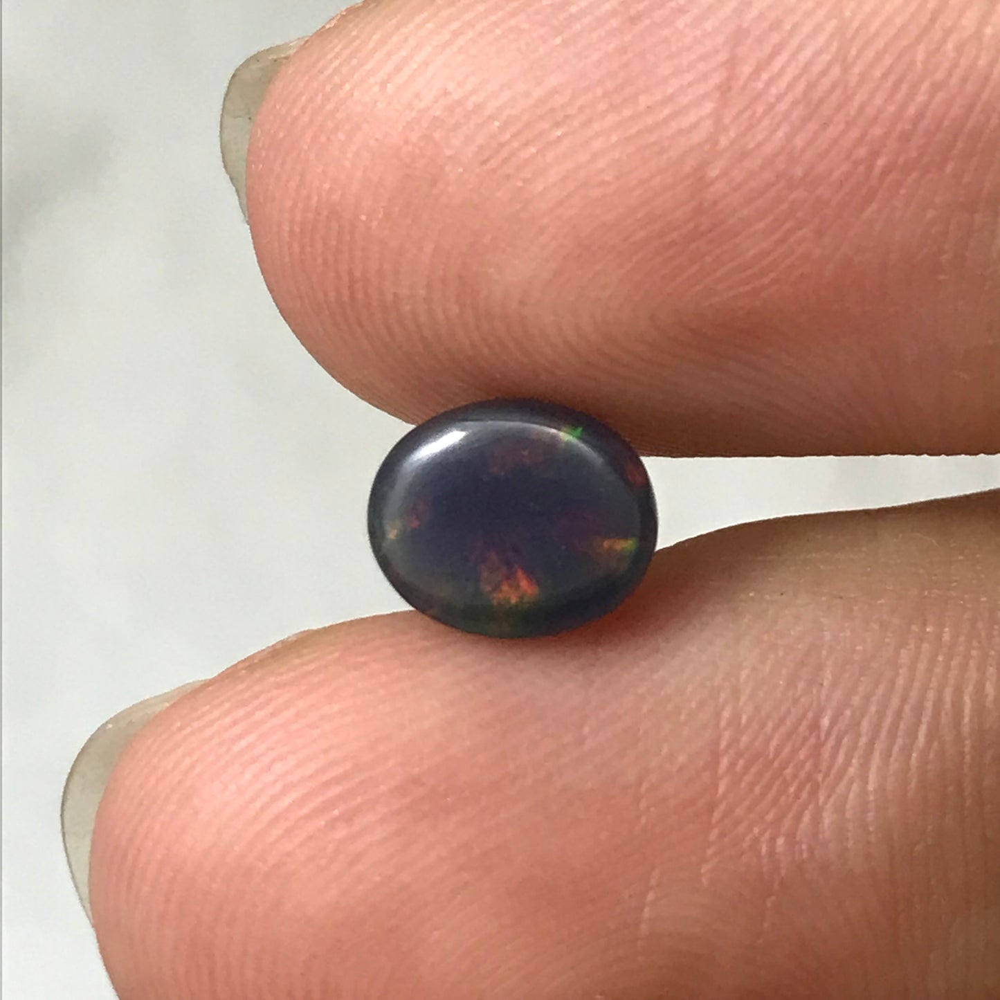 Black Opal 0.98 carat 8x6.5mm Oval Cabochon, Green Orange & Yellow Play of Color, Smoke Enhanced Natural Opal