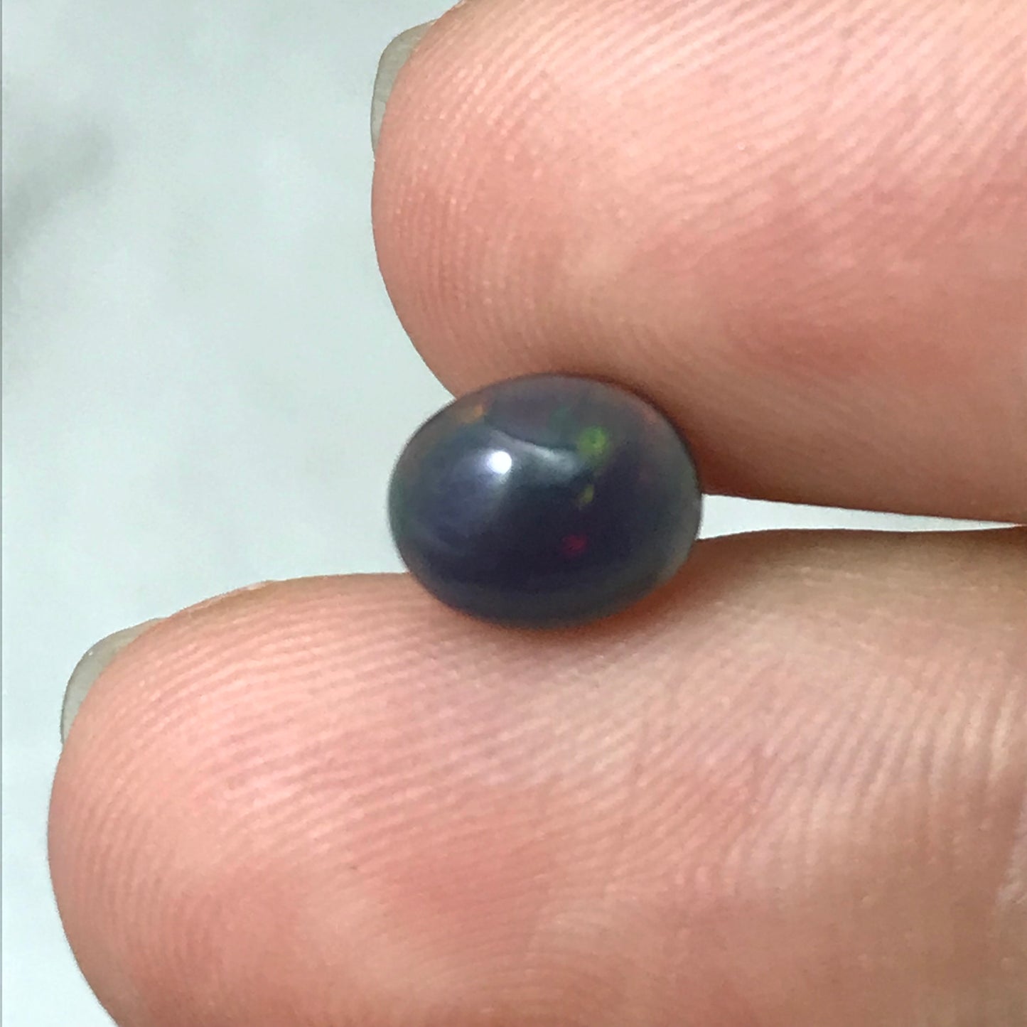 Black Opal 0.98 carat 8x6.5mm Oval Cabochon, Green Orange & Yellow Play of Color, Smoke Enhanced Natural Opal