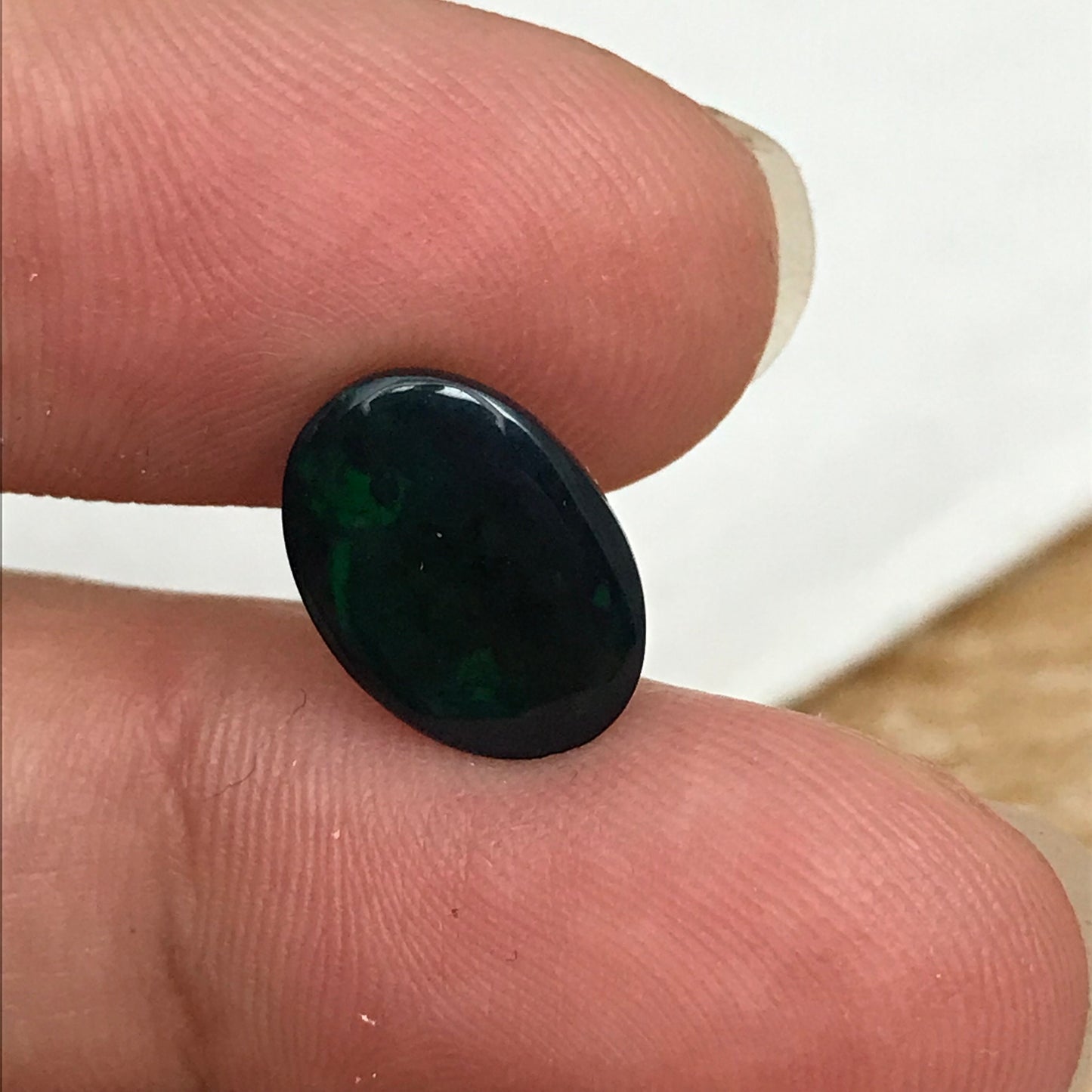 Black Opal 2.33 carat 11.8x8.7mm Oval Cabochon, Heat/Sugar  Enhanced Natural Opal