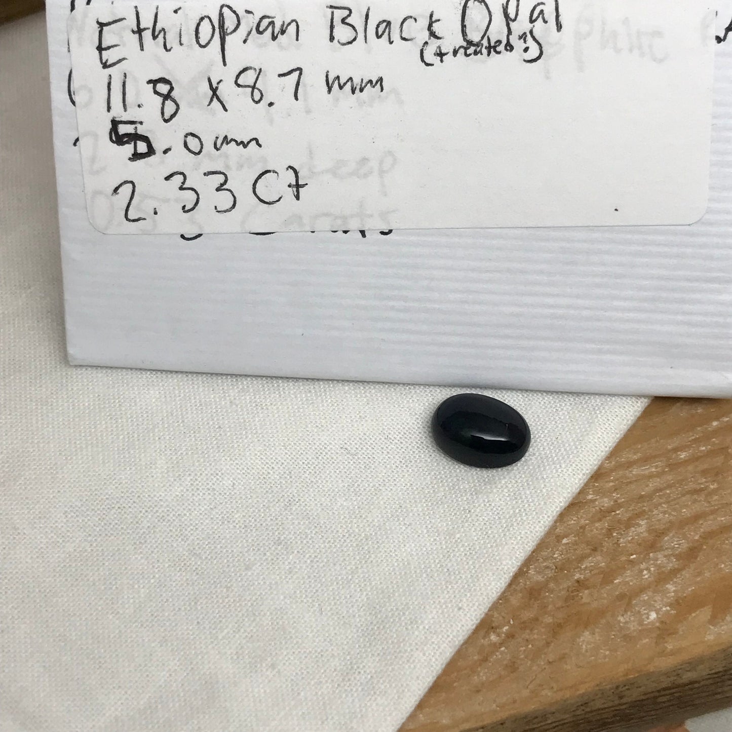 Black Opal 2.33 carat 11.8x8.7mm Oval Cabochon, Heat/Sugar  Enhanced Natural Opal