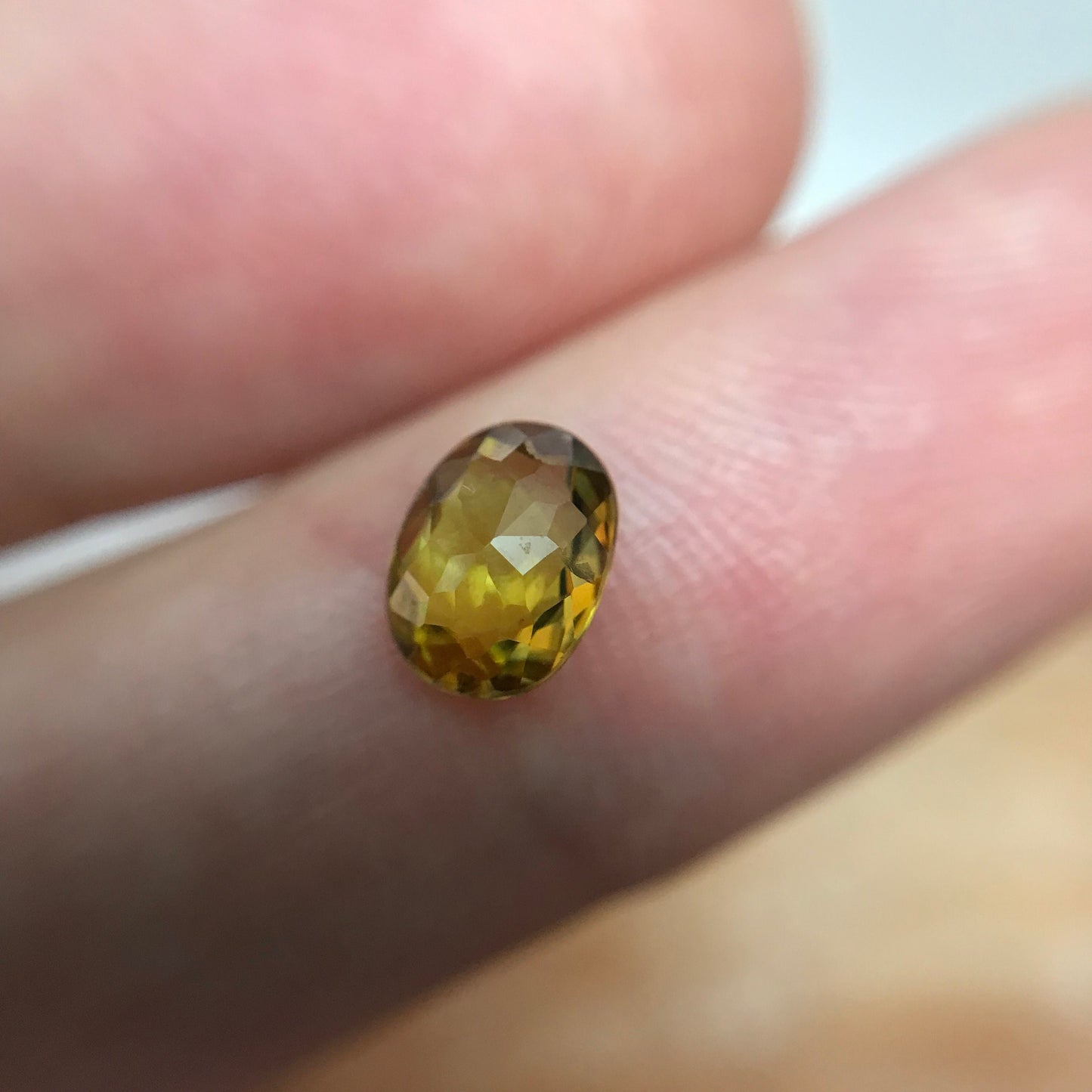 7x5mm Yellow Sphene Oval Cut, 0.84 Carat Natural Orangish Yellow Sphene with Rainbow Flashes