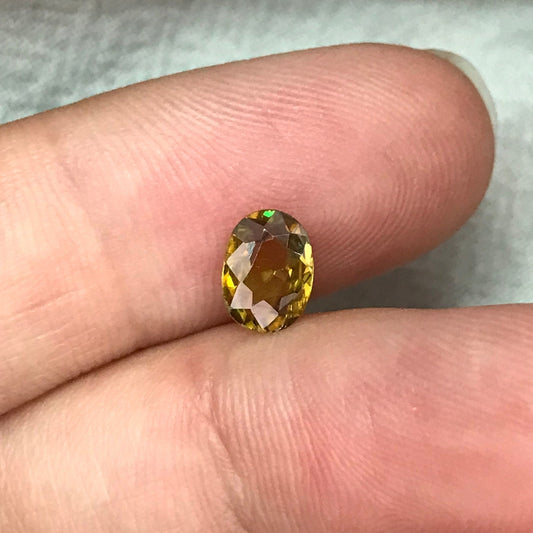 7x5mm Yellow Sphene Oval Cut, 0.84 Carat Natural Orangish Yellow Sphene with Rainbow Flashes