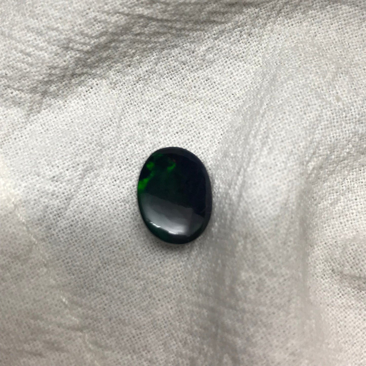 Black Opal 2.33 carat 11.8x8.7mm Oval Cabochon, Heat/Sugar  Enhanced Natural Opal