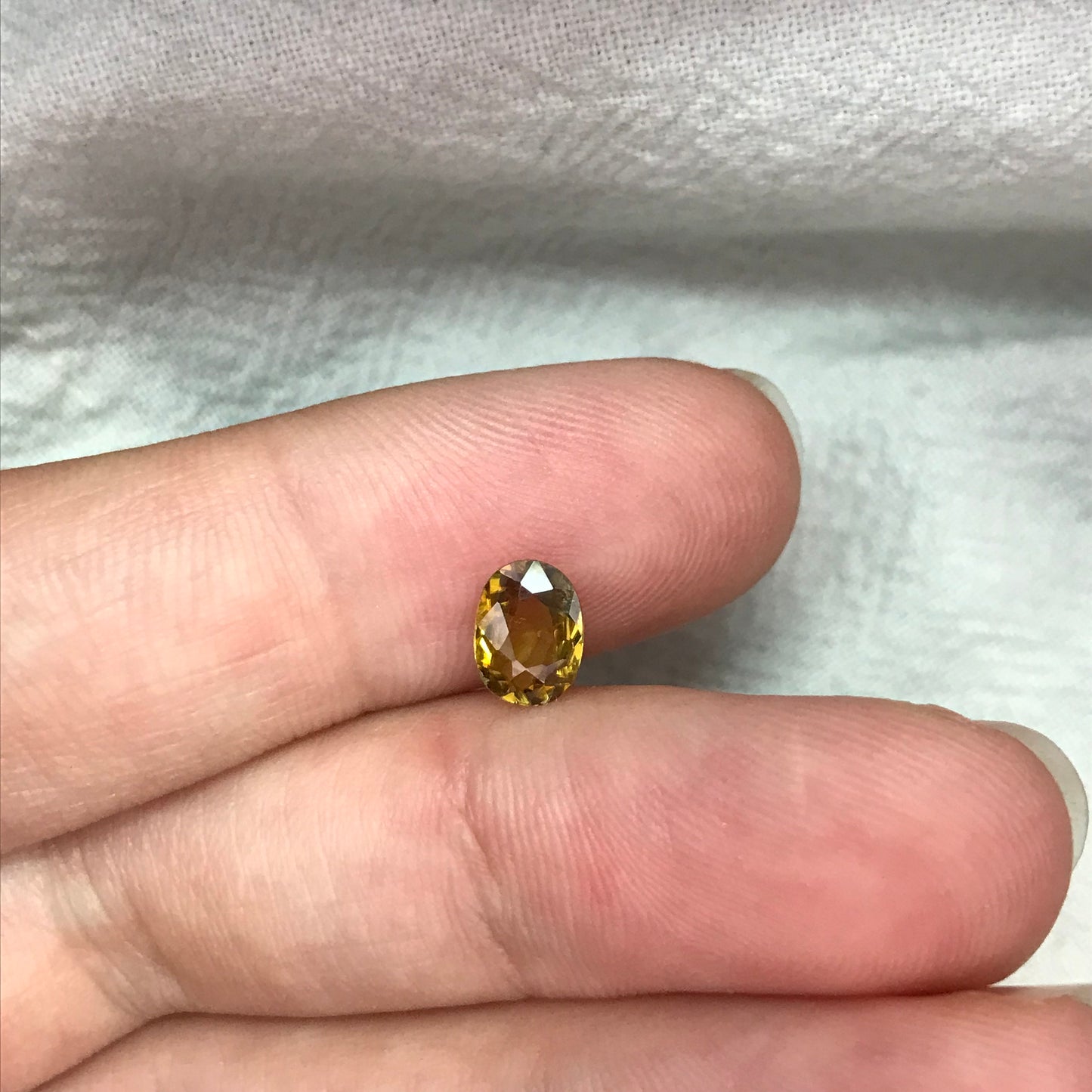 7x5mm Yellow Sphene Oval Cut, 0.84 Carat Natural Orangish Yellow Sphene with Rainbow Flashes