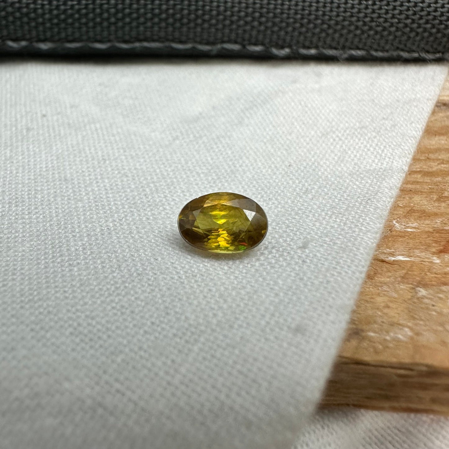 7x5mm Yellow Sphene Oval Cut, 0.92 Carat Natural Orangish Yellow Sphene with Rainbow Flashes