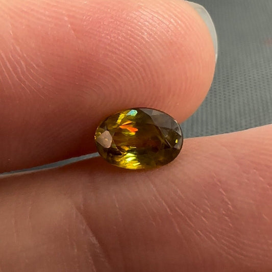 7x5mm Yellow Sphene Oval Cut, 0.92 Carat Natural Orangish Yellow Sphene with Rainbow Flashes
