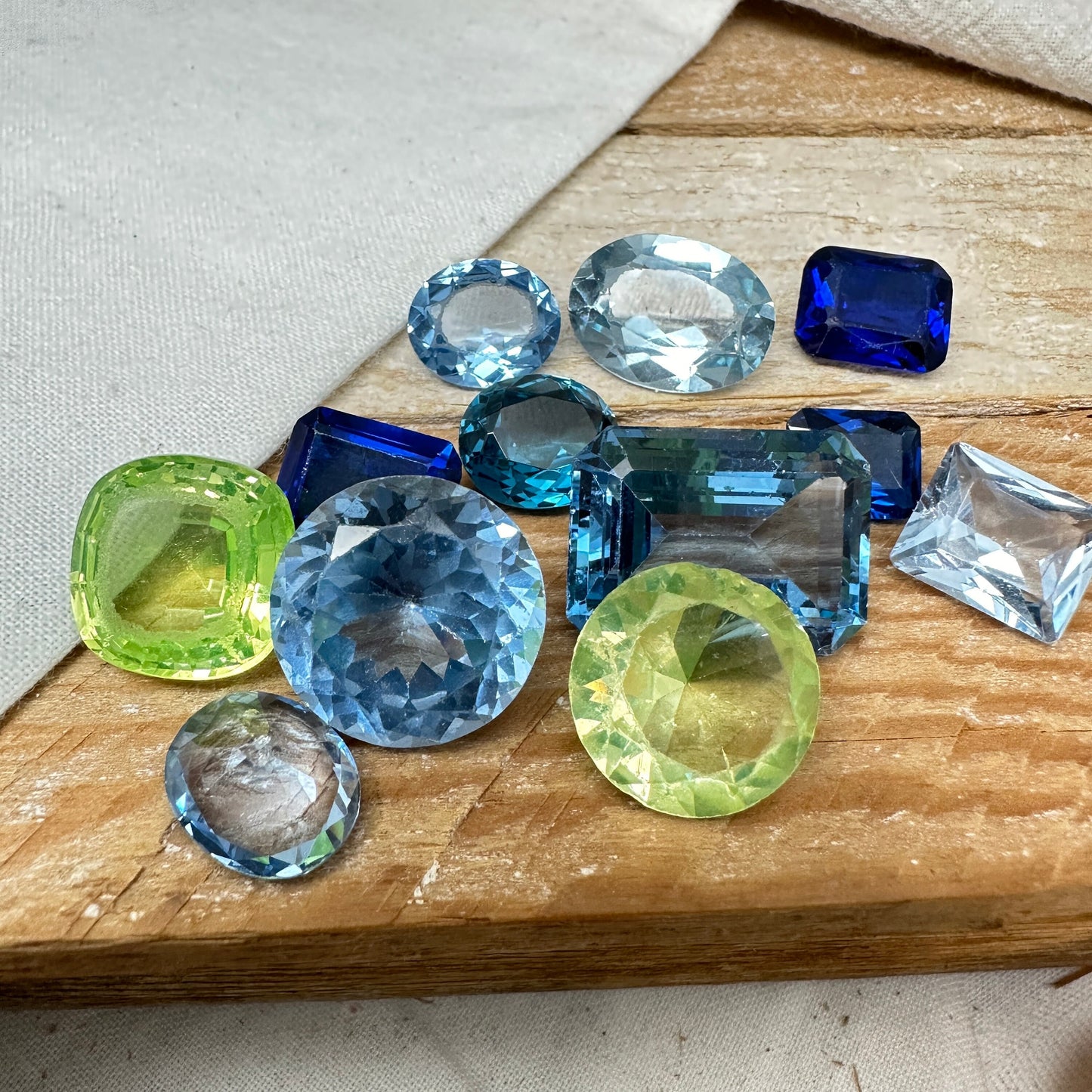 116 carat Lot of Lab Created Spinel 12 stones, Discounted Worn, Faceted, Recycled, Chipped, Damaged Gemstones, Blue and Yellow Green