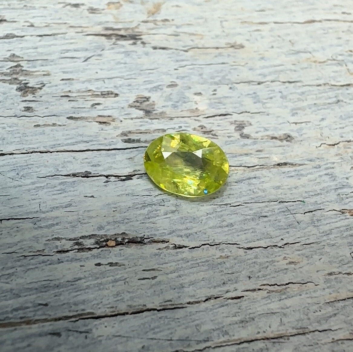 0.93 Yellow Green Sphene with Rainbow Flashes 7.3x5.3mm Oval Cut, Faceted Loose Titanite