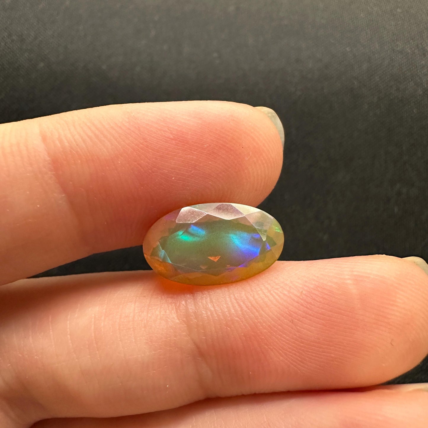 3 Carat Ethiopian Opal 14.65x8.6mm Oval Cut, Faceted Loose Opal, Green Orange Yellow Blue Color Play