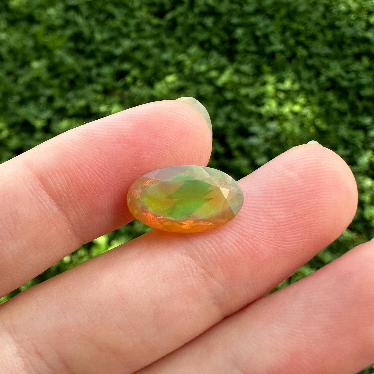 3 Carat Ethiopian Opal 14.65x8.6mm Oval Cut, Faceted Loose Opal, Green Orange Yellow Blue Color Play