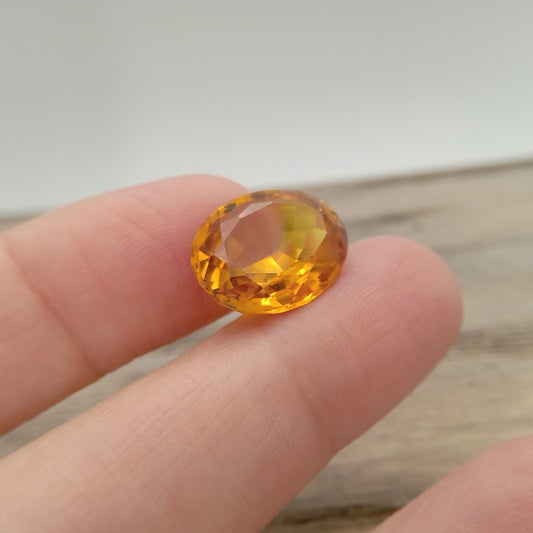 15.9mm x 12.2mm Oval Orange Yellow Synthetic Sapphire, 11.49 carat, Faceted Loose Gemstone