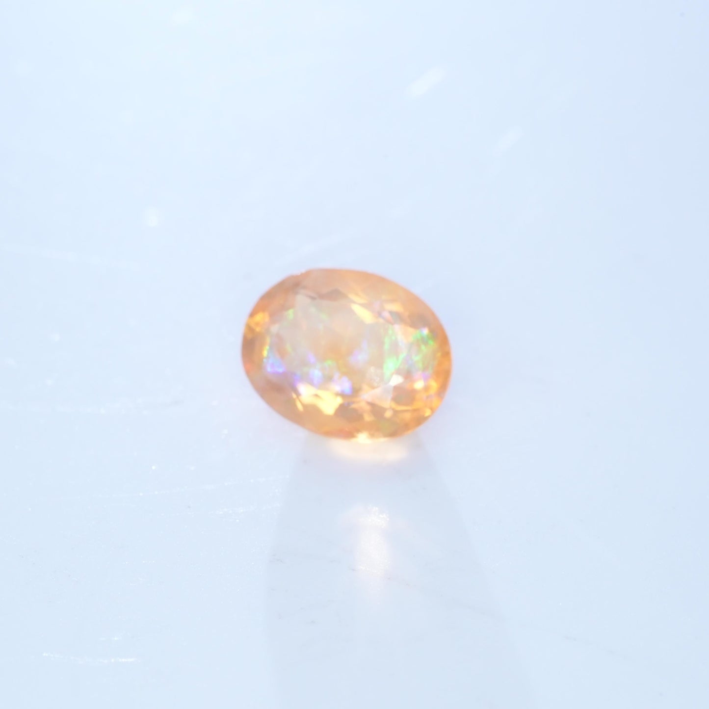 3.41 carat Orange Fire Opal with color play, 12.3x9.7mm Oval Cut