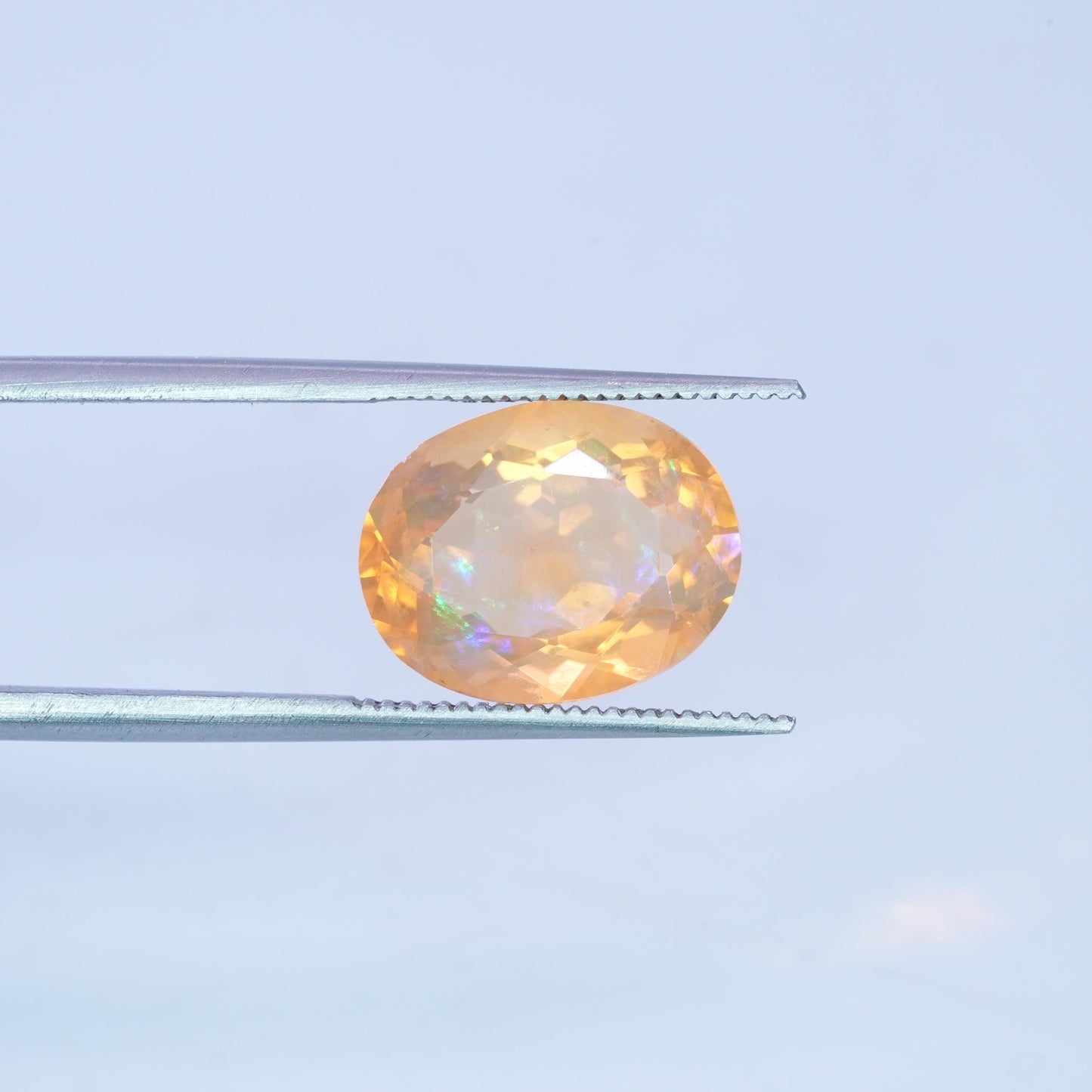 3.41 carat Orange Fire Opal with color play, 12.3x9.7mm Oval Cut