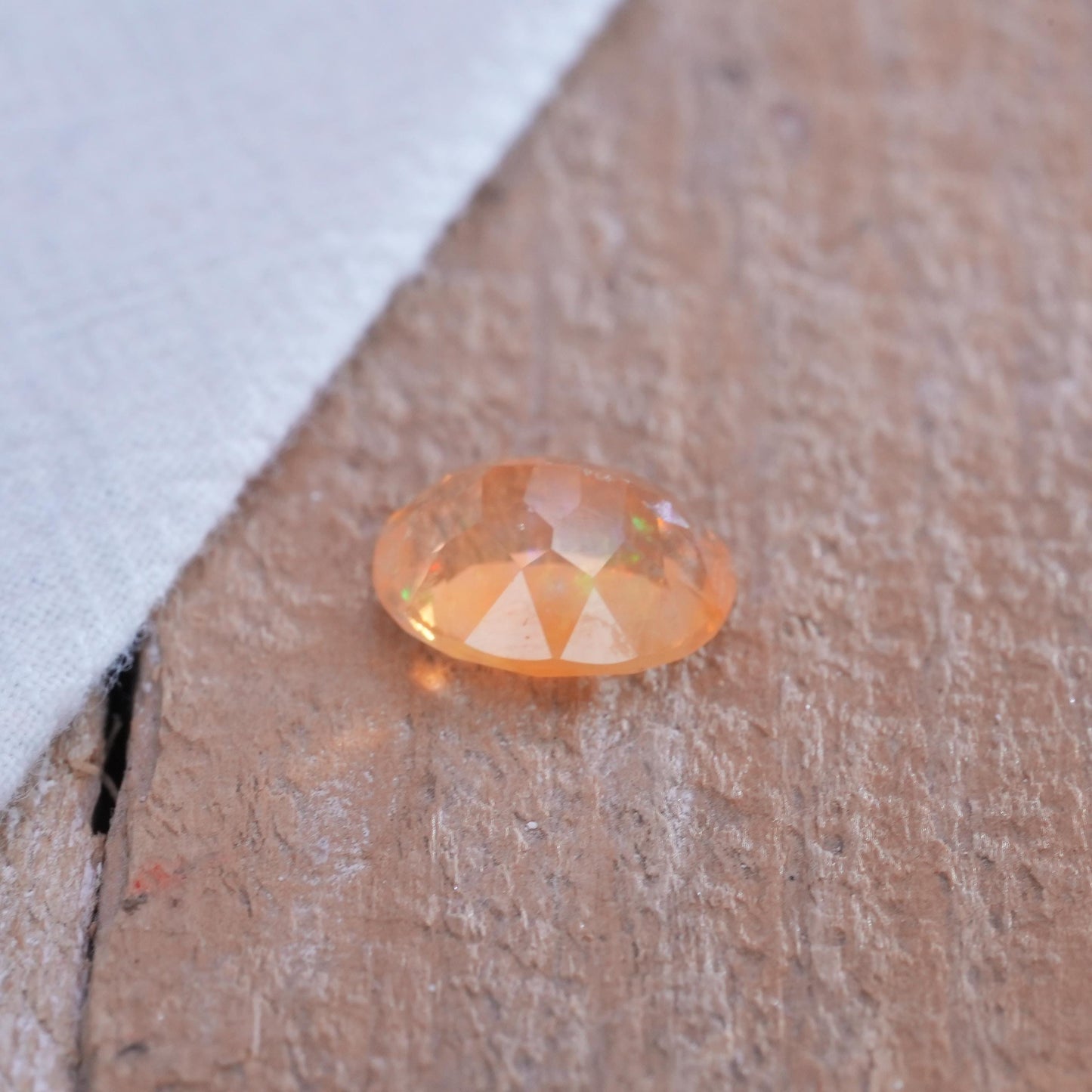 3.41 carat Orange Fire Opal with color play, 12.3x9.7mm Oval Cut