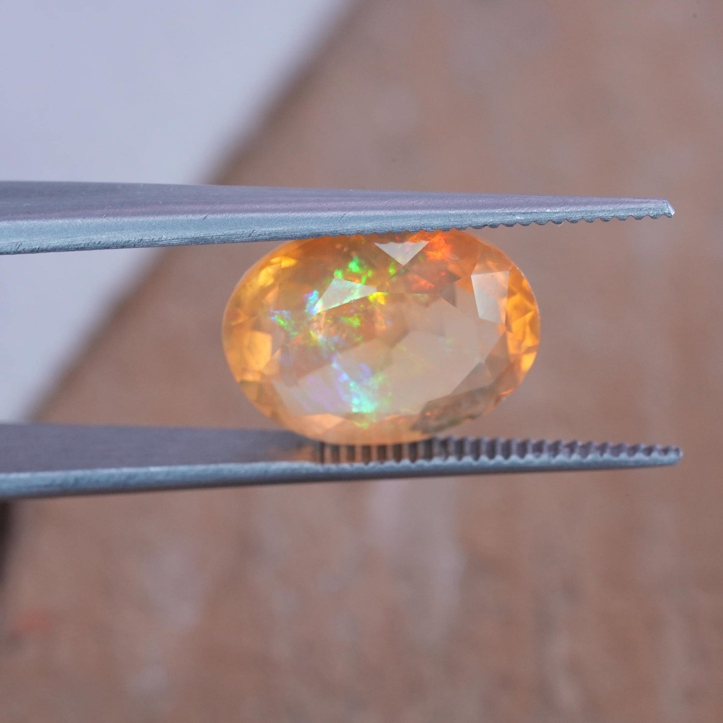 3.41 carat Orange Fire Opal with color play, 12.3x9.7mm Oval Cut