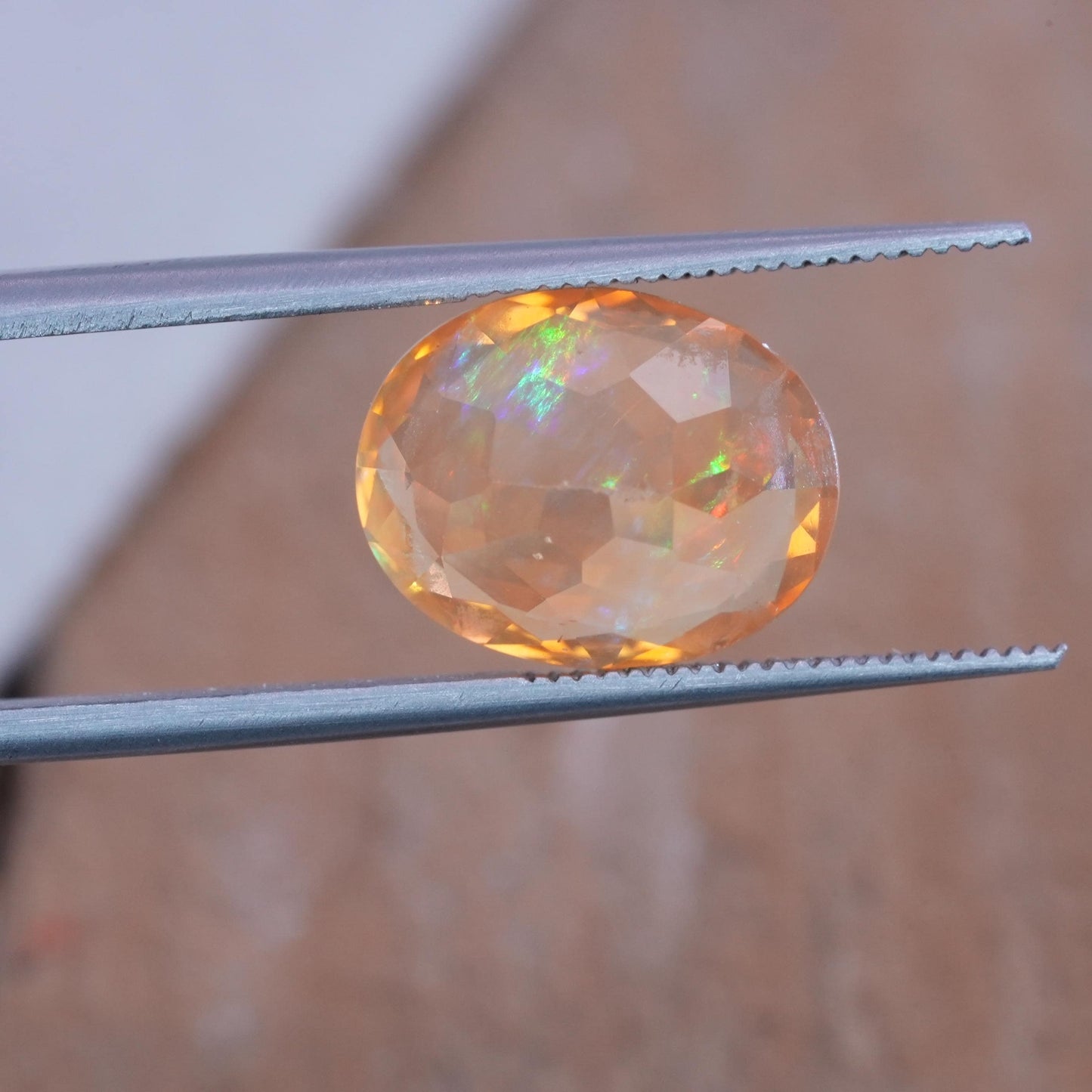 3.41 carat Orange Fire Opal with color play, 12.3x9.7mm Oval Cut