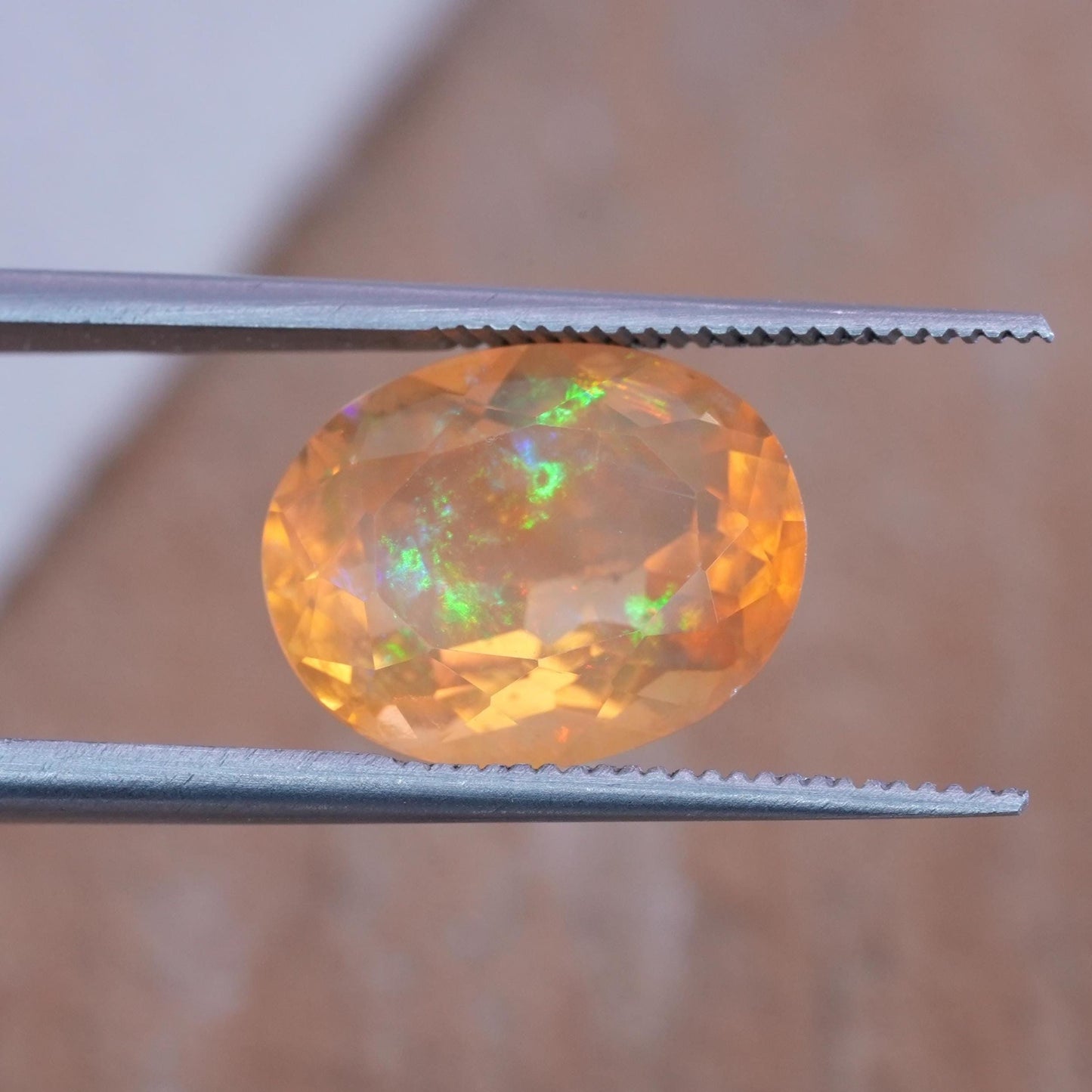 3.41 carat Orange Fire Opal with color play, 12.3x9.7mm Oval Cut