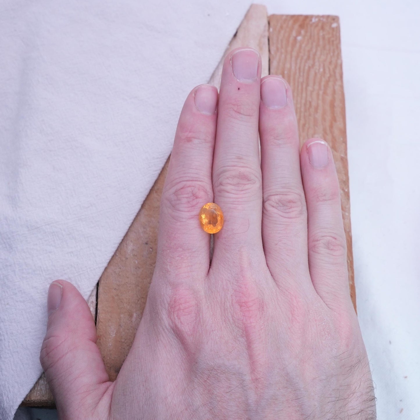 3.41 carat Orange Fire Opal with color play, 12.3x9.7mm Oval Cut