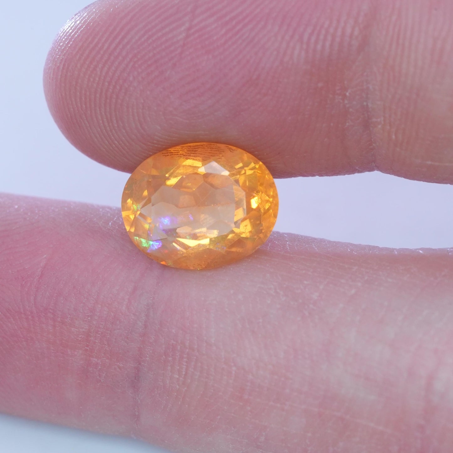 3.41 carat Orange Fire Opal with color play, 12.3x9.7mm Oval Cut