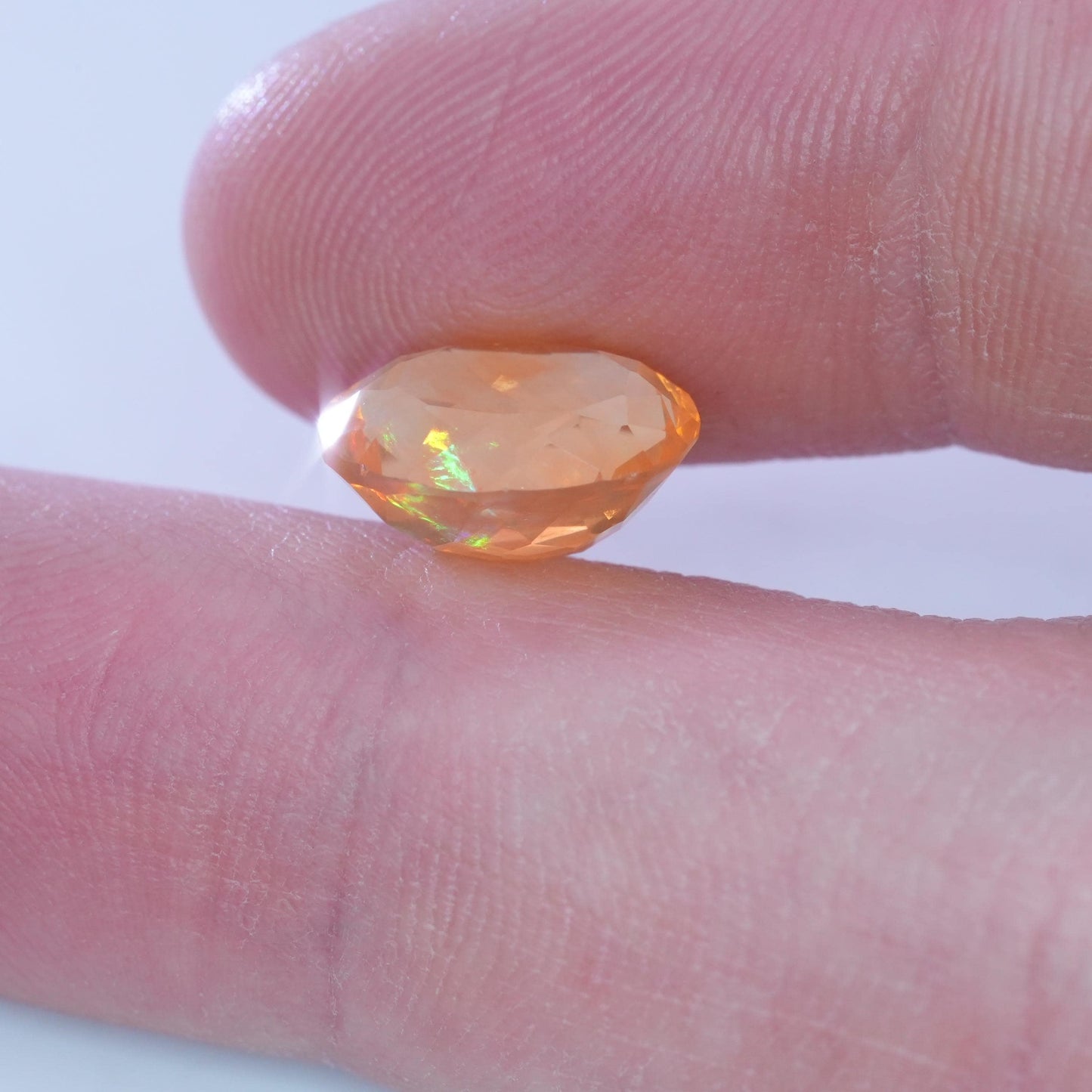 3.41 carat Orange Fire Opal with color play, 12.3x9.7mm Oval Cut