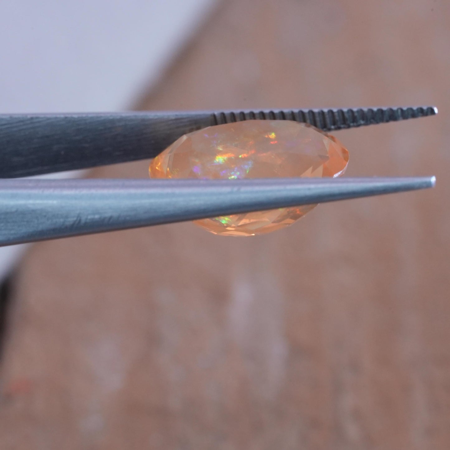 3.41 carat Orange Fire Opal with color play, 12.3x9.7mm Oval Cut