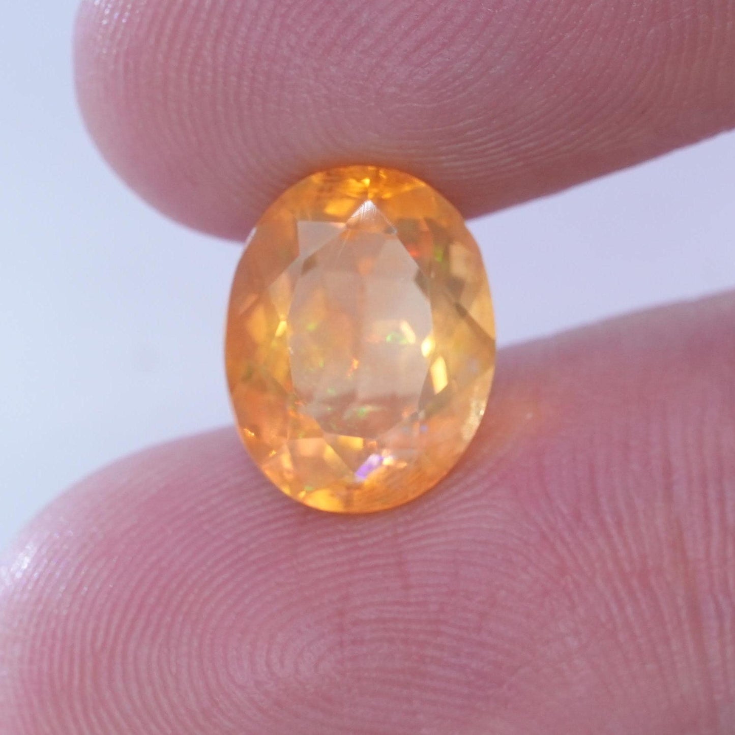 3.41 carat Orange Fire Opal with color play, 12.3x9.7mm Oval Cut